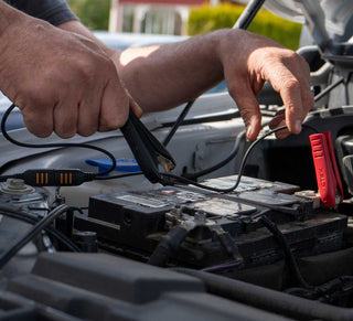 Hands working with battery clamps