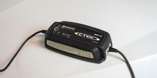 CTEK battery charger with a rubber cover on a white surface